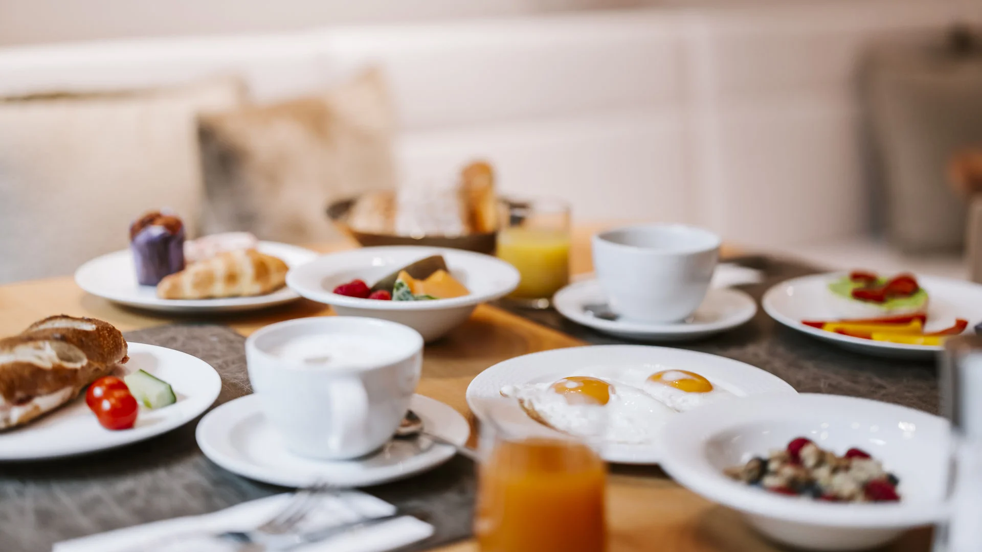 Assorted breakfast dishes and drinks on a set table