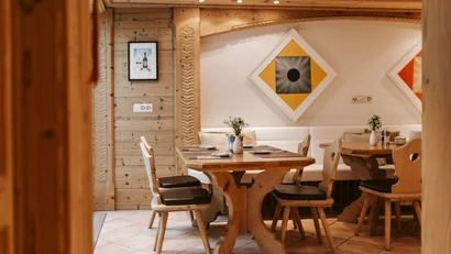 Cozy wooden dining area with decorative wall art and table decorations