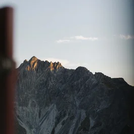 Mountain peak at sunset viewed through window frame
